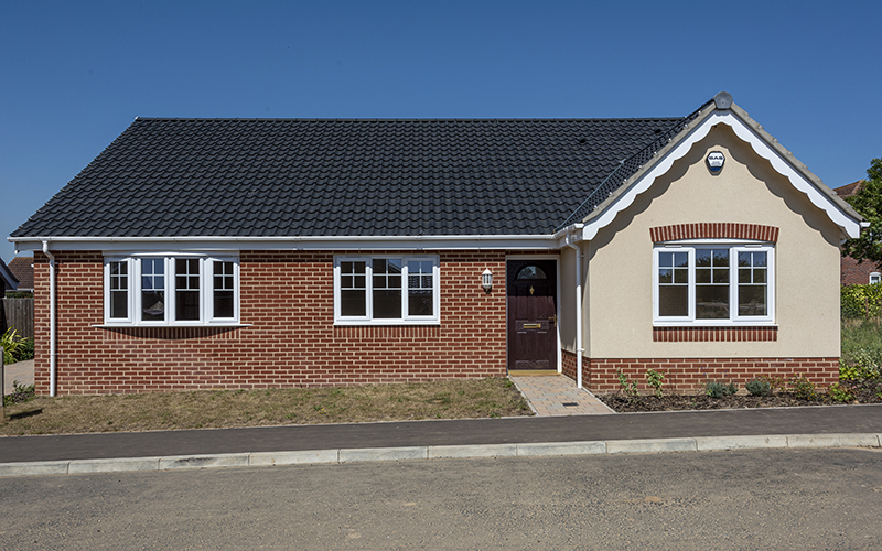 Badger Building Claydon Park Bungalow 2 New build bungalow with blue skies and planted front garden
