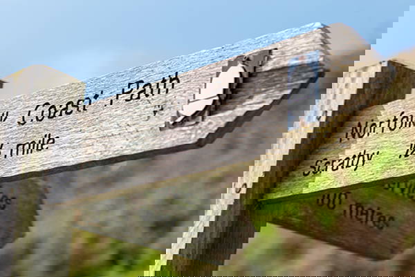 Street view in the town of Beccles in Suffolk with the Church towering over the surrounding buildings
