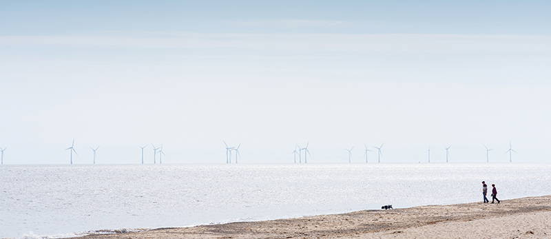 View of Beccles thoroughfare with colourful bunting flags and flowers in the foreground