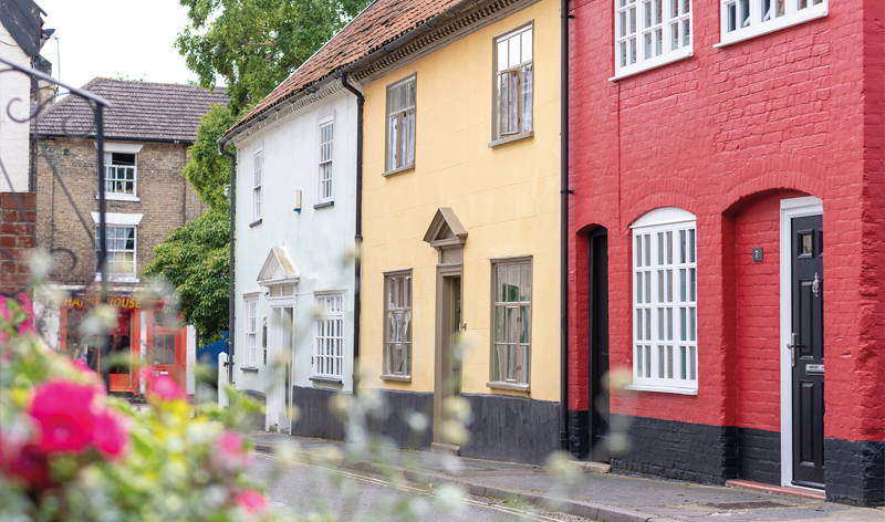View of Beccles thoroughfare with colourful bunting flags and flowers in the foreground